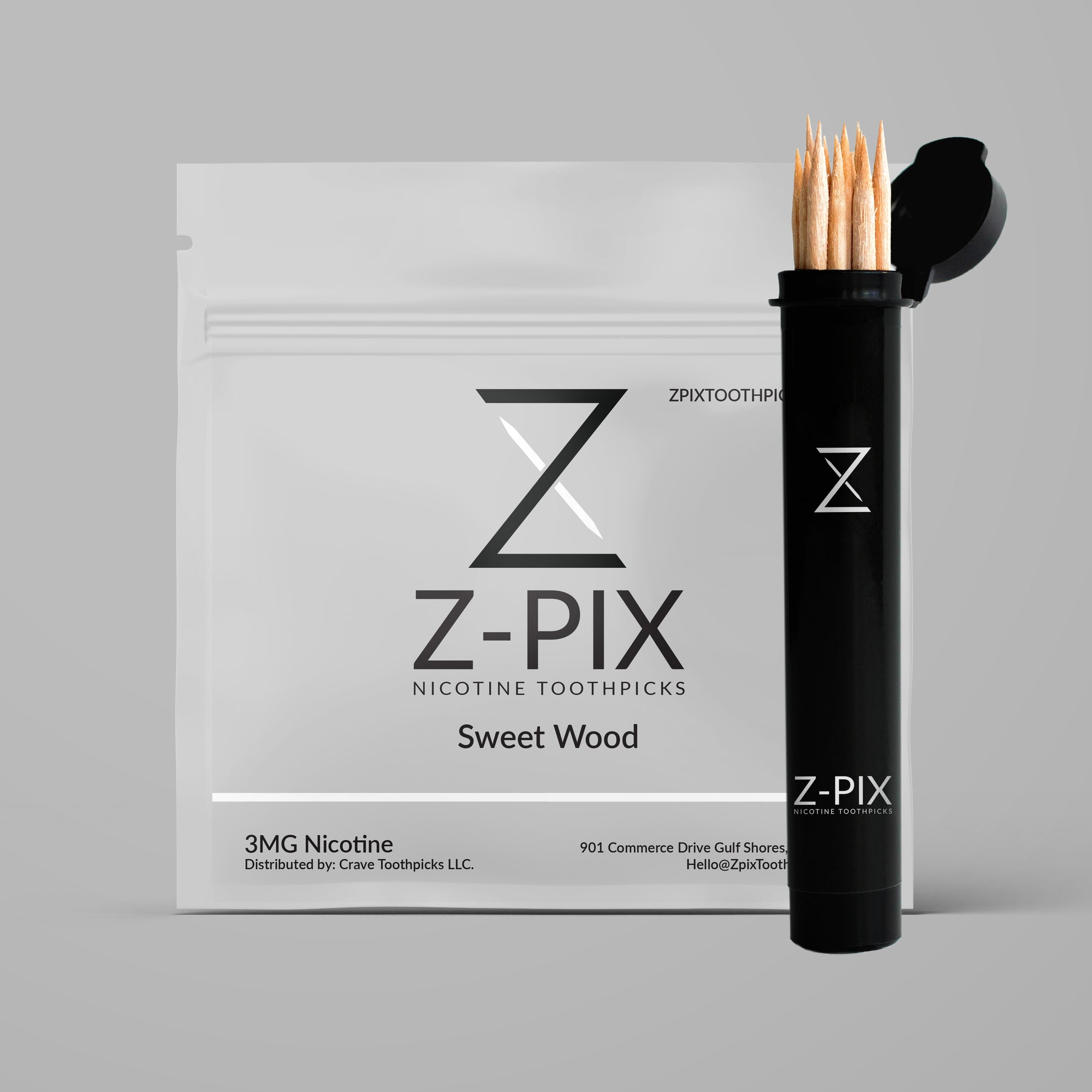 Z-Pix Sweet Wood nicotine toothpicks shown with their white branded packaging box and a black cylindrical holder containing several toothpicks, on a plain gray background.
